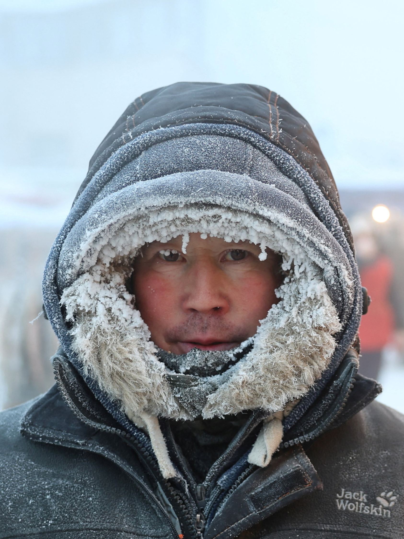 A vendor poses for a picture at a local market on a frosty day in Yakutsk
