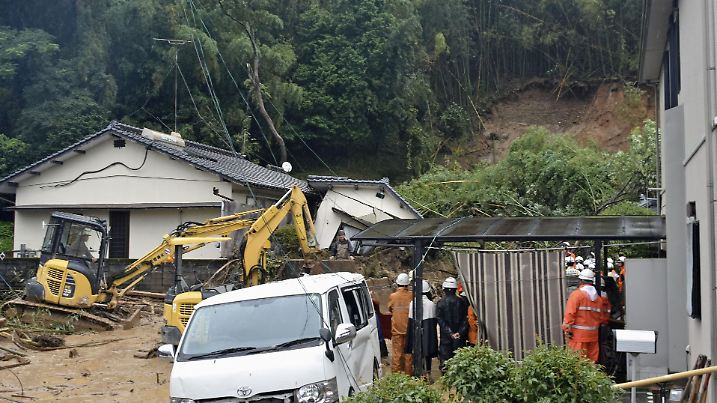 Rescue workers conduct search and rescue operation for a missing man at the landslide site caused by heavy rain in Kosa Town, Japan