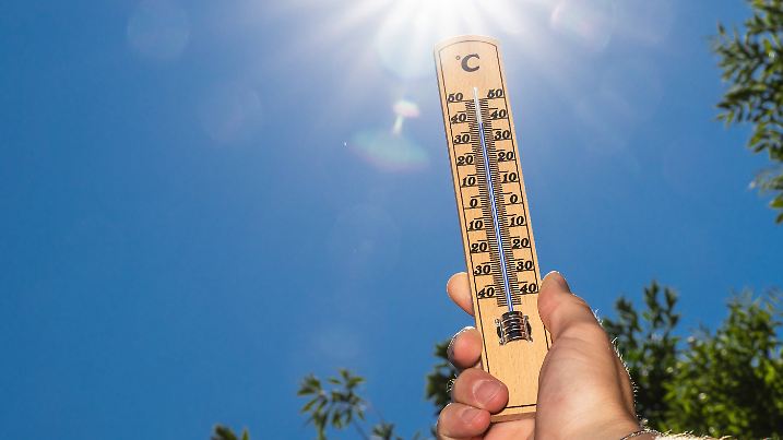 Bavaria, Germany - 30 June 2025: A thermometer in front of bright sunlight shows temperatures close to 40 degrees - this