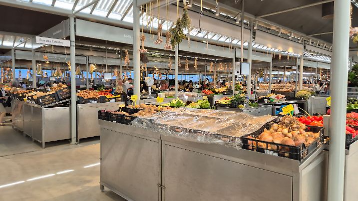 Porto, Portugal - July 17 2025: Inside Mercado do Bolhão in Porto, Portugal, a historic city icon bustling with locals and vendors, in a renovated traditional market space.