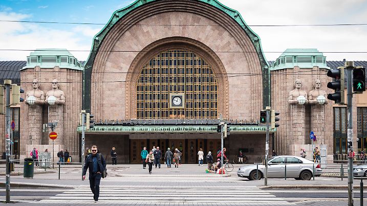 Helsinki, Finland - June 3, 2015: View of people, cars and the Helsinki Central Station building in Helsinki - Finland