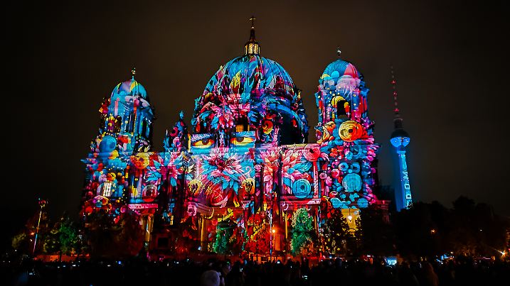 Berlin, Germany - October 6, 2024: Crowd of people enjoy the illumination show on the facade of famous Berlin Cathedral (Berliner Dom) during annual Festival of Lights in Berlin