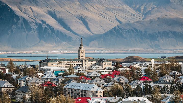 Cityscape of downtown Reykjavik in Iceland, featuring colourful houses, Tækniskólinn college and mountain Esjan in the background