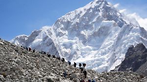 FILE PHOTO: Mountaineers and trekkers head towards the Everest base camp from Lobuche in the Solukhumbu district, also known as the Everest region