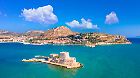 The old town of Nafplio in Greece with tiled roofs, small port, bourtzi castle, Palamidi fortress