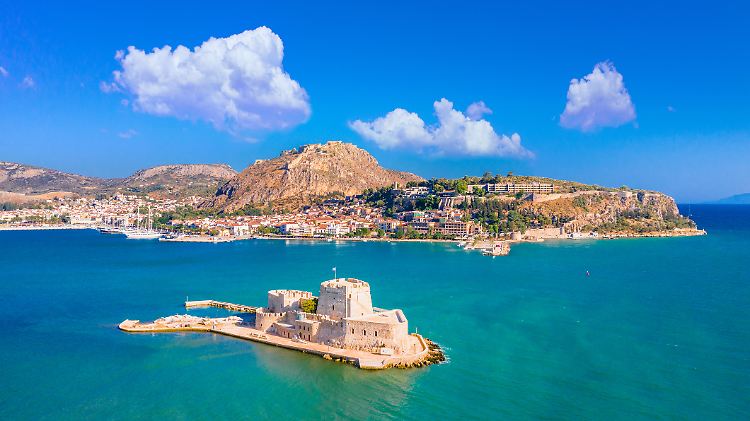 The old town of Nafplio in Greece with tiled roofs, small port, bourtzi castle, Palamidi fortress