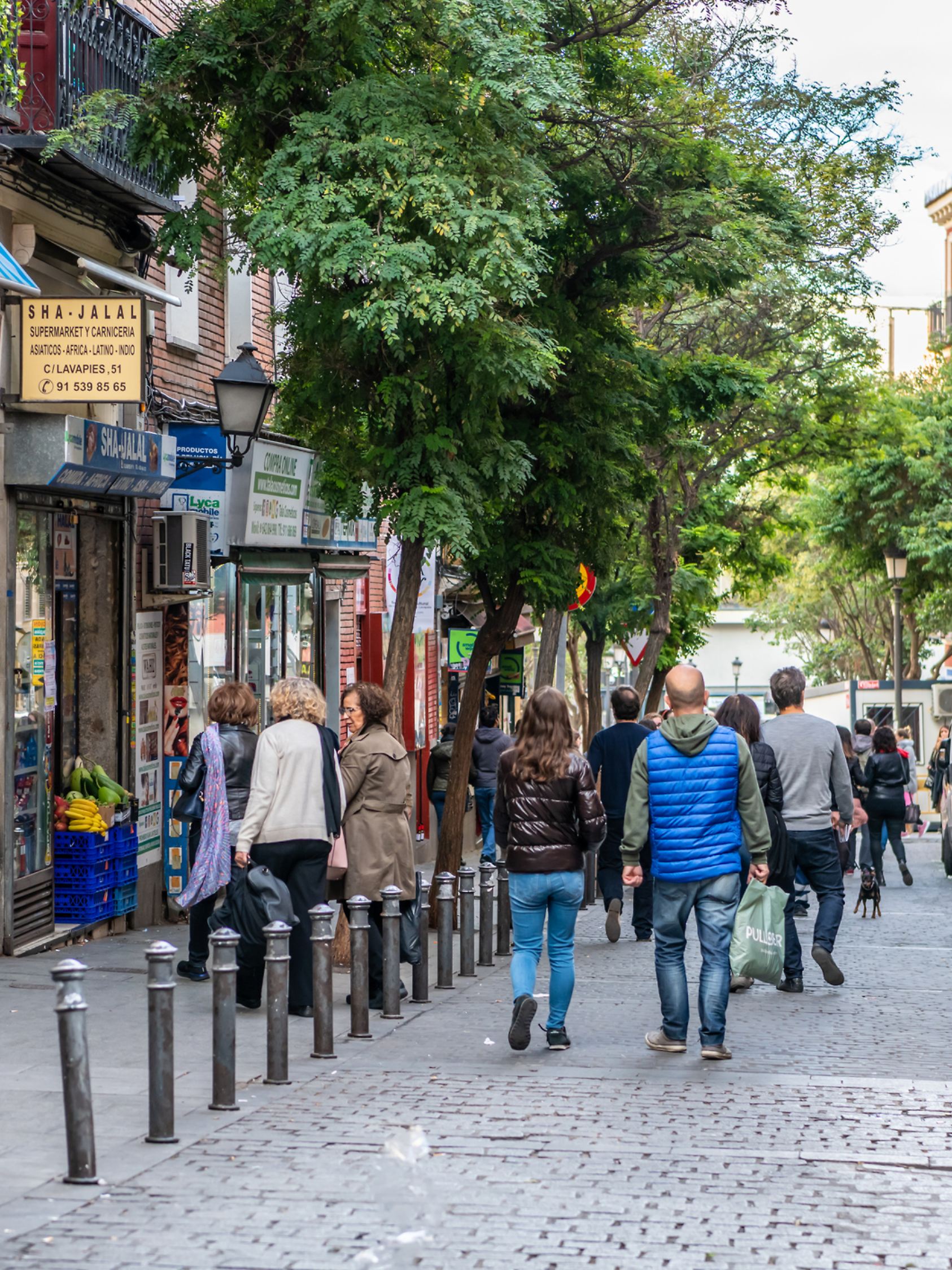Madrid / Spain - October 19, 2019: People wander the popular Lavapies neighborhood in central Madrid, known for its great nightlife.