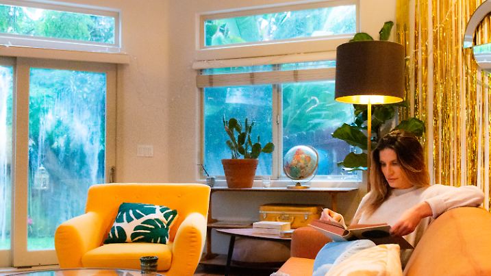 Woman reading at home on a rainy day