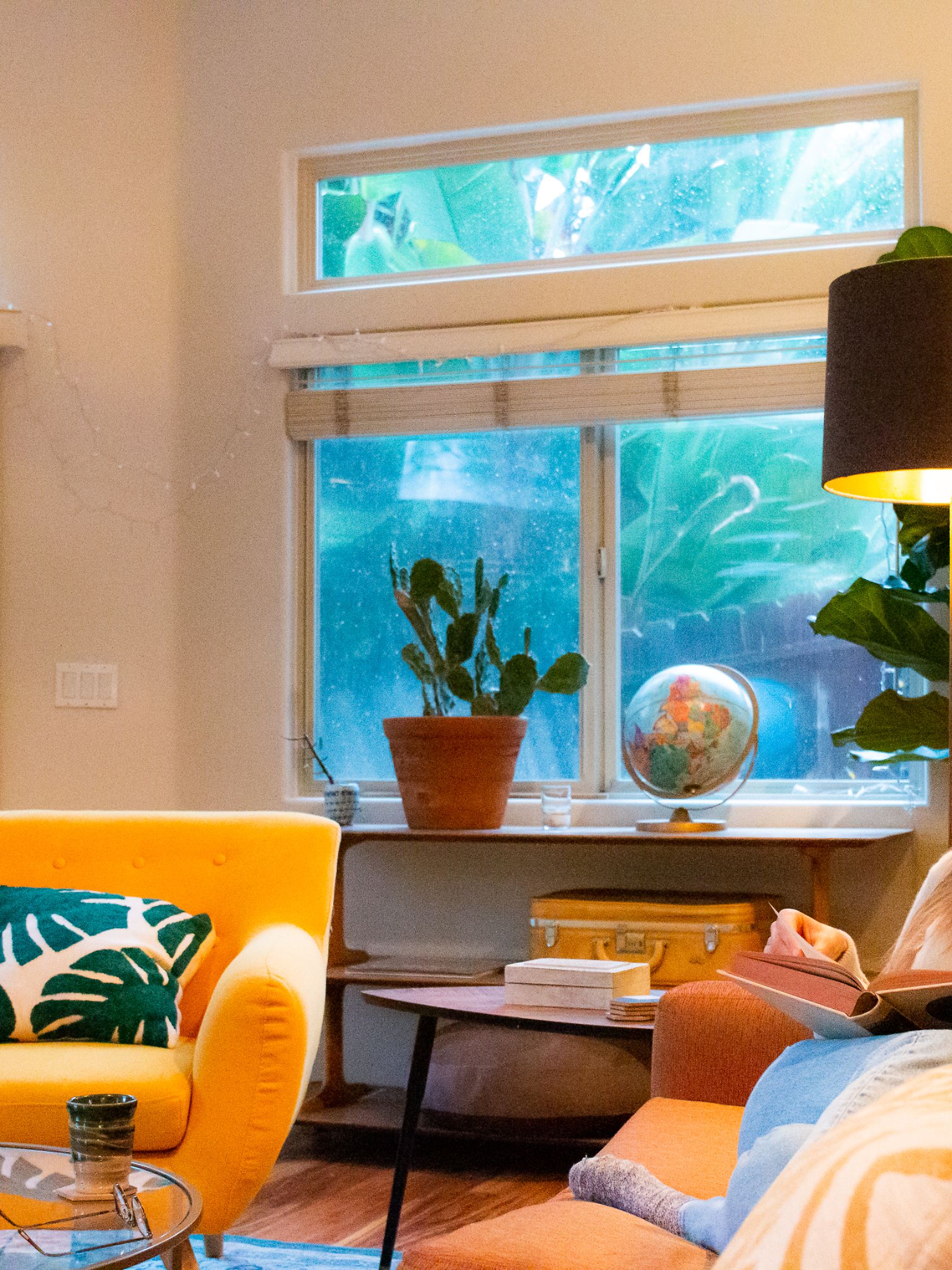 Woman reading at home on a rainy day
