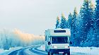 Vacation trip with Caravan Car on winter snow road of Finland. Camper and Summer drive on highway. Holiday journey in rv motorhome for recreation. Motor home minivan motion ride. Mini van vehicle.