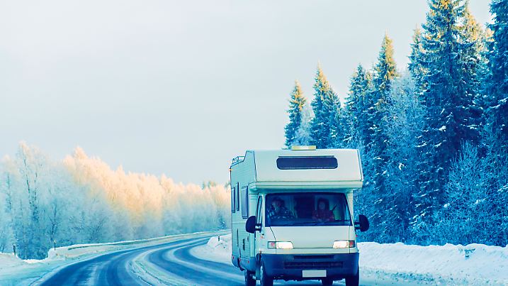 Vacation trip with Caravan Car on winter snow road of Finland. Camper and Summer drive on highway. Holiday journey in rv motorhome for recreation. Motor home minivan motion ride. Mini van vehicle.