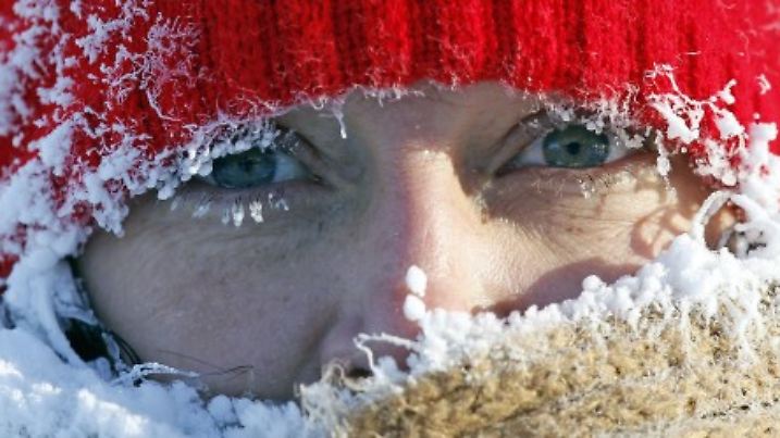 Ice from the breath of Gail Davis forms around her face as she exercises by walking outside in Minneapolis, January 8, 2014.  A deadly blast of arctic air shattered decades-old temperature records as it enveloped the eastern United States on Tuesday, snarling air, road and rail travel, driving energy prices higher and overwhelming shelters for homeless people. According to AccuWeather.com, the extreme cold won't last much longer. The frigid air and "polar vortex" that affected about 240 million people in the United States and southern Canada will depart during the second half of this week, and a far-reaching January thaw will begin, according to AccuWeather.com.  REUTERS/Eric Miller (UNITED STATES - Tags: ENVIRONMENT TPX IMAGES OF THE DAY)