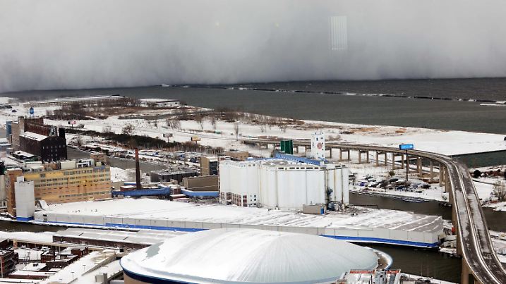 A lake-effect snow storm with freezing temperatures produces a wall of snow travelling over Lake Erie into Buffalo, New York. November 18, 2014. A whirlpool of frigid, dense air known as a "polar vortex" descended Tuesday into much of the Northeastern U.S. REUTERS/Gary Wiepert (UNITED STATES - Tags: ENVIRONMENT)