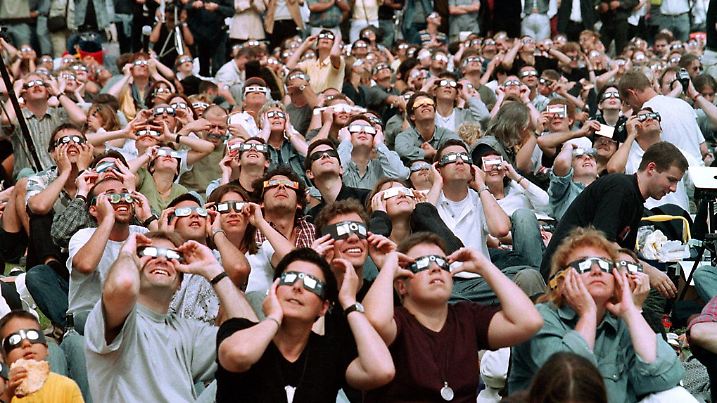 Tausende von Menschen beobachten am 11.08.1999 in der Innenstadt von Karlsruhe die totale Sonnenfinsternis (Archivfoto). Mehr als 500000 Menschen hatten damals allein in Karlsruhe die Sonnenfinsternis miterlebt. Jetzt lässt ein seltenes Himmelsschauspiel die Herzen in der türkischen Tourismusbranche höher schlagen: Dank der totalen Sonnenfinsternis am kommenden Mittwoch (29. März) sind zahlreiche Hotels komplett ausgebucht, etliche beginnen die Saison früher als üblich. Zur besten Beobachtungszeit über Mittag wird der Mond in einem rund 165 Kilometer breiten Streifen das Tagesgestirn komplett verdunkeln und wenige Minuten lang dunkle Nacht einkehren lassen. Foto: Uli Deck dpa (zu dpa-Korr "Sonnenfinsternis im Badeparadies - Türkei erwartet Himmelsschauspiel" am 23.03.2006) +++(c) dpa - Bildfunk+++