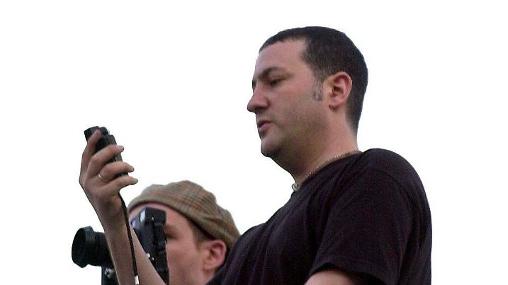 US artist-photographer Spencer Tunick (R) checks his hand photometer as he measures the morning light during a photo session with hundreds of naked people in Barcelona, 08 June 2003. EPA-PHOTO/EFE/JULIAN MARTIN |