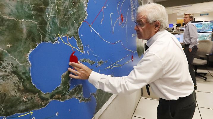 National Oceanic and Atmospheric Administration public affairs officer Dennis Feltgen updates the progress of Hurricane Michael on a large map, Tuesday, Oct. 9, 2018, at the Hurricane Center in Miami. At least 120,000 people along the Florida Panhandle were ordered to clear out Tuesday as Hurricane Michael rapidly picked up steam in the Gulf of Mexico and closed in with winds of 110 mph (175 kph) and a potential storm surge of 12 feet (3.7 meters). (AP Photo/Wilfredo Lee) |