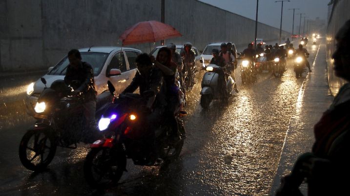 Commuters on their vehicles move through an underpass during a heavy rain shower in Ahmedabad, India, September 18, 2015. Rains were 16 percent below average so far over the four-month monsoon season that ends this month due to an El Nino weather pattern, which can lead to scorching weather across Asia and east Africa but heavy rains and floods in South America. REUTERS/Amit Dave