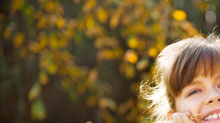 autumn kid with maple leaves