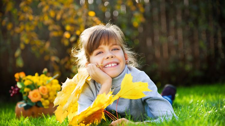autumn kid with maple leaves