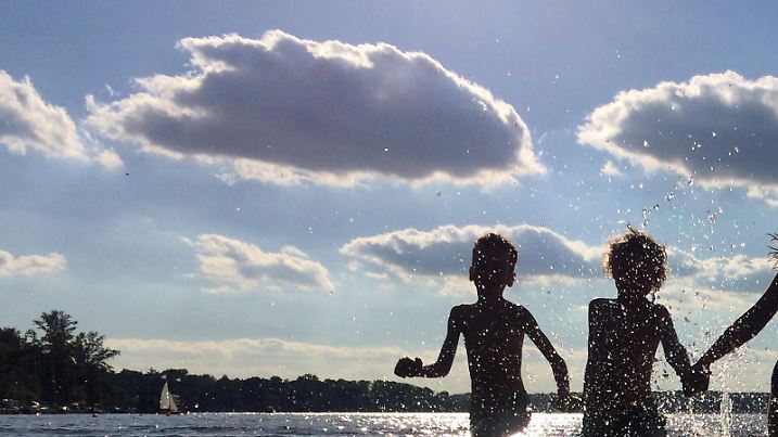 Kinder laufen am 26.05.2017 in Berlin im Standbad Wannsee durch das kühle Nass. Die Meteorologen sagen für das Wochenende (26./28.05.2017) sommerliches Wetter mit Temperaturen bis 30 Grad voraus. Foto: Stephanie Pilick/dpa | Verwendung weltweit