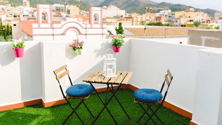 White terrace for coffee overlooking the village and Mexican mountain, blue sky.